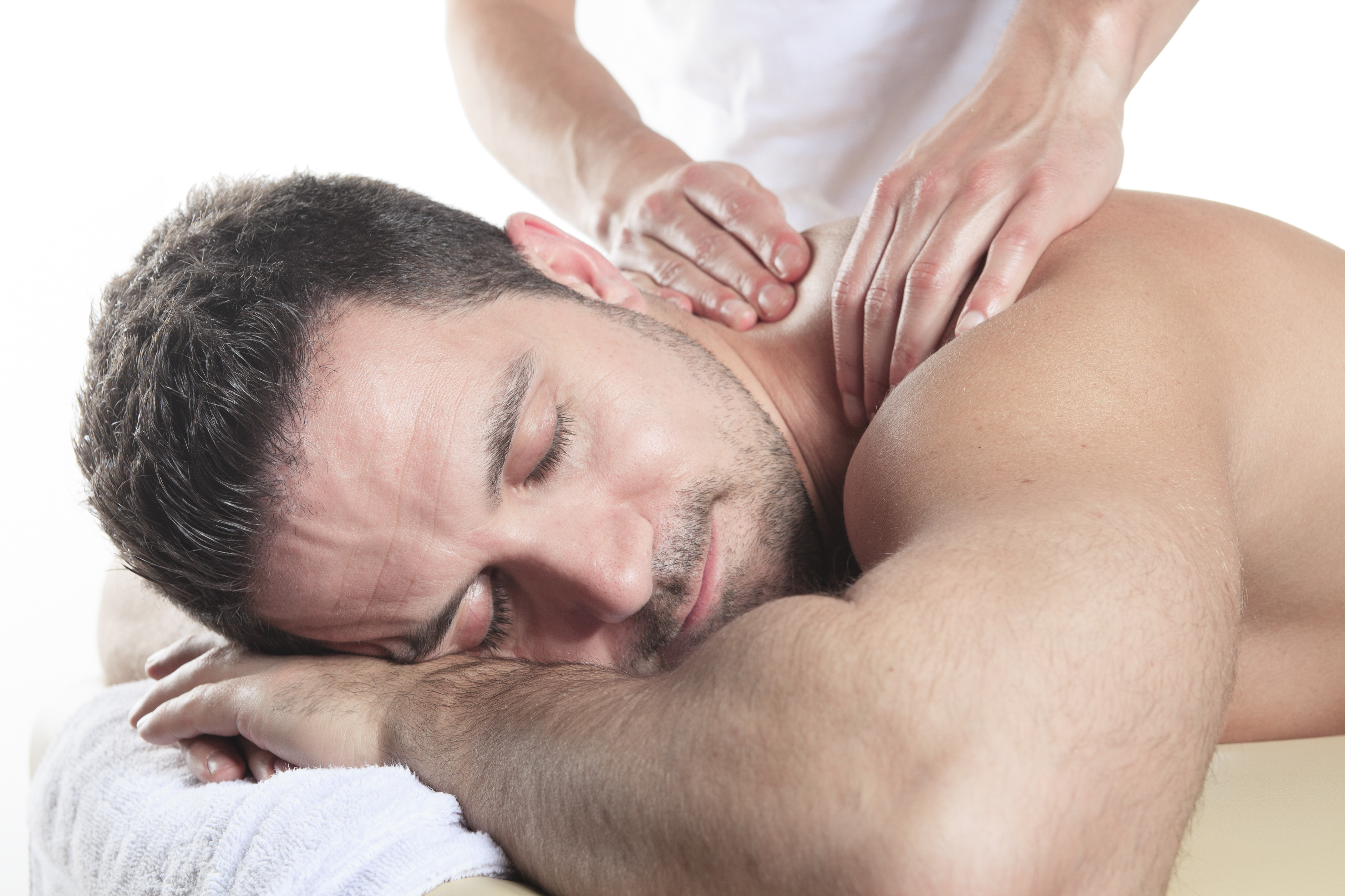 Man receiving Shiatsu massage from a professional masseur at spa salon